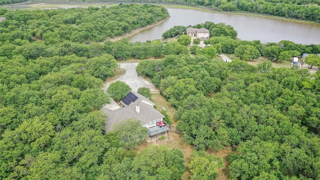 drone / aerial view with a water view and a wooded view