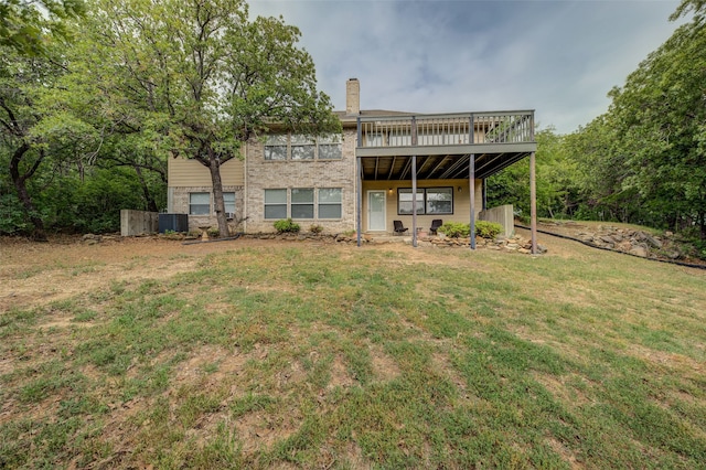 back of house with central AC, a lawn, and a wooden deck