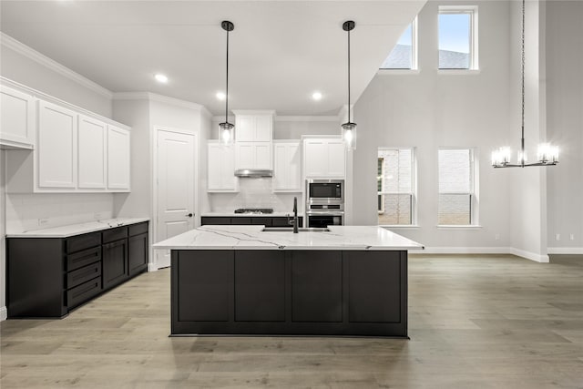 kitchen featuring white cabinets, appliances with stainless steel finishes, light hardwood / wood-style floors, and sink