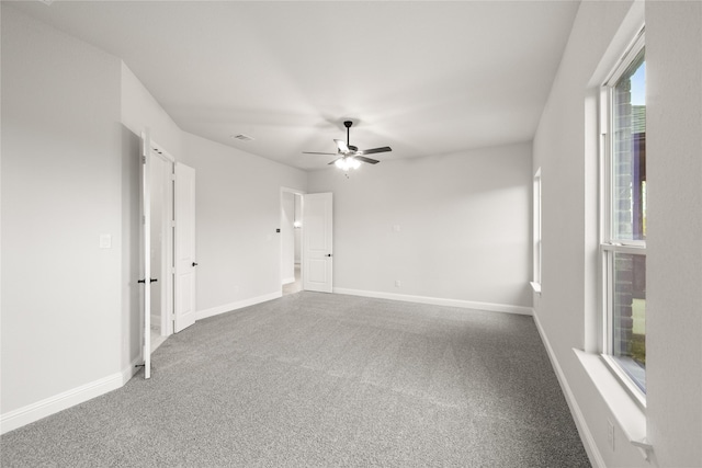 empty room with ceiling fan and carpet