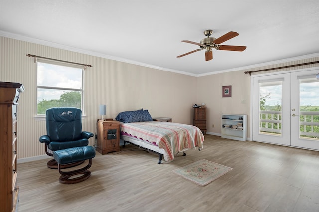 bedroom featuring multiple windows, access to exterior, light hardwood / wood-style flooring, and ceiling fan