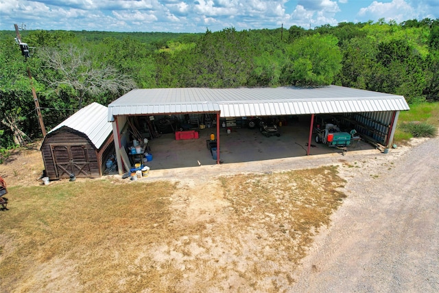 view of front of house with a carport and an outbuilding