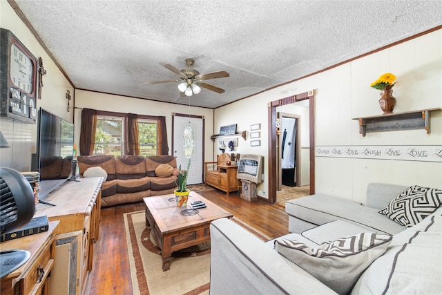 living room featuring dark hardwood / wood-style floors, ceiling fan, and a textured ceiling