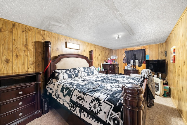 bedroom with carpet floors, wooden walls, and a textured ceiling