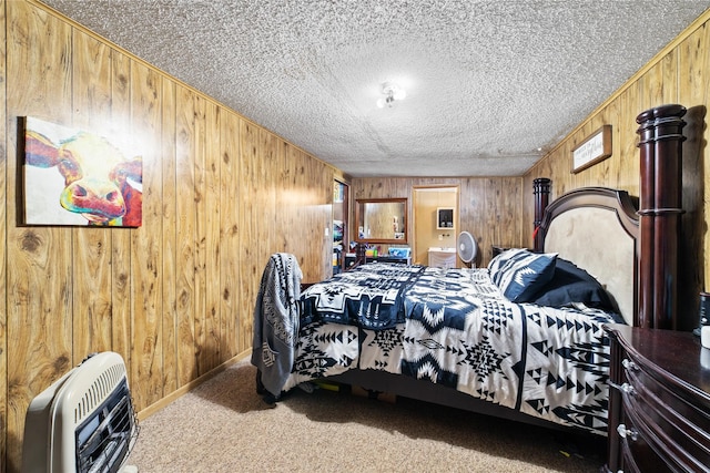 carpeted bedroom featuring a textured ceiling, wood walls, baseboards, and heating unit