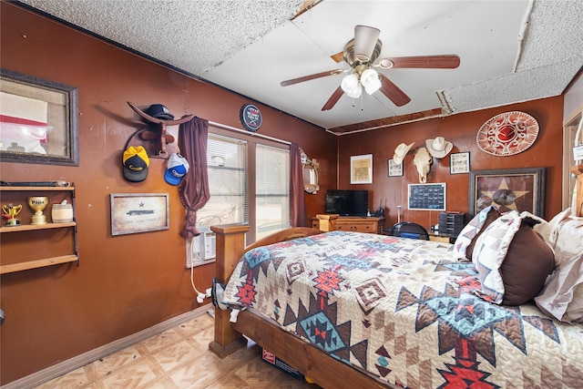 bedroom with light parquet floors, a textured ceiling, cooling unit, and ceiling fan