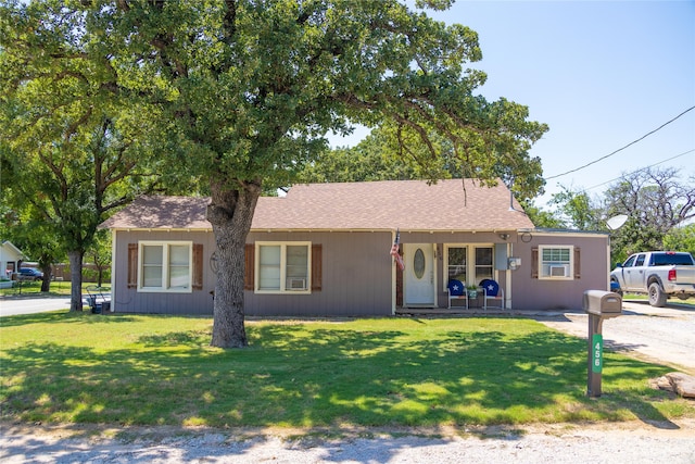 single story home with a front lawn