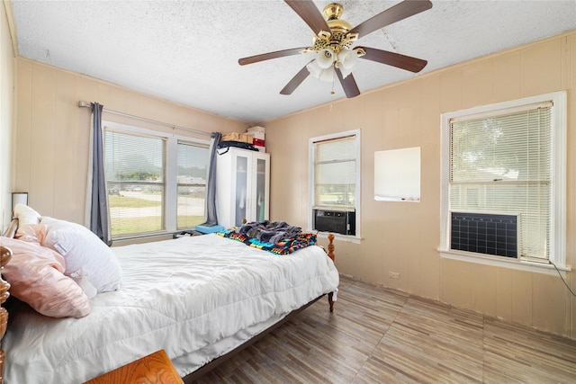 bedroom with ceiling fan and a textured ceiling