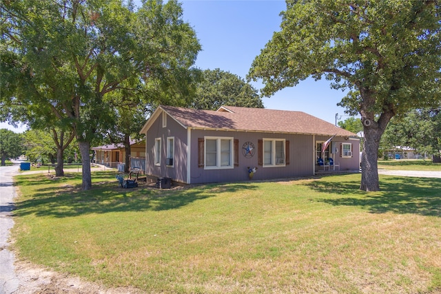 view of front of house featuring central AC and a front yard