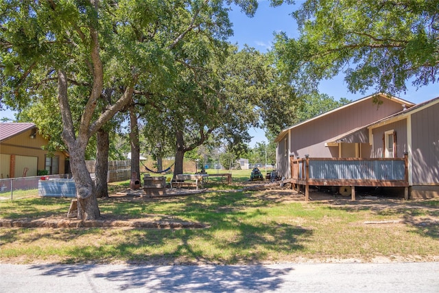 view of yard with a wooden deck and fence