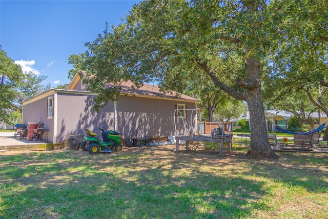 view of side of home featuring a lawn