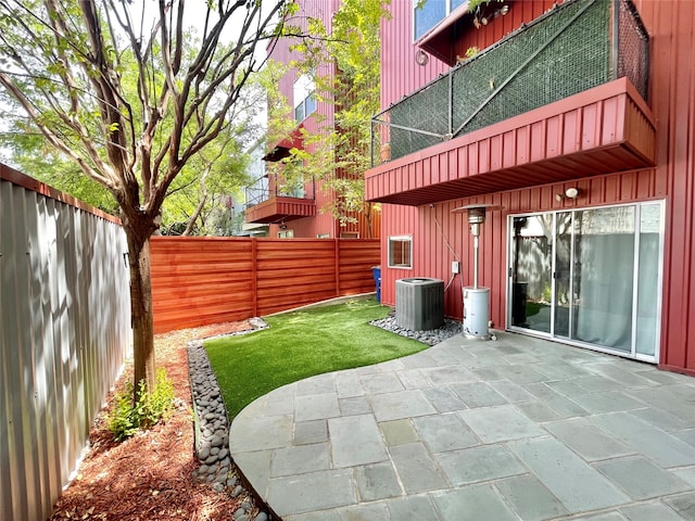 view of patio / terrace with cooling unit and a fenced backyard