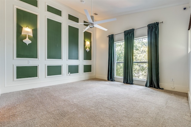 unfurnished room with ceiling fan and carpet flooring