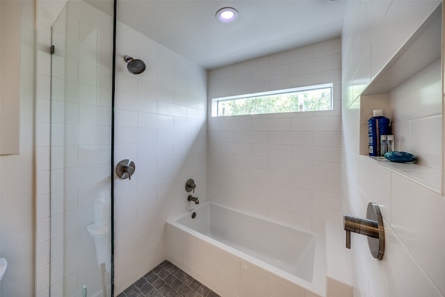 bathroom featuring tile patterned flooring and tiled shower / bath