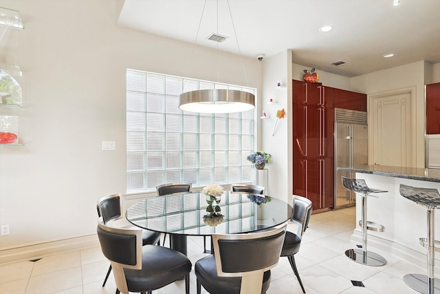 tiled dining room with plenty of natural light