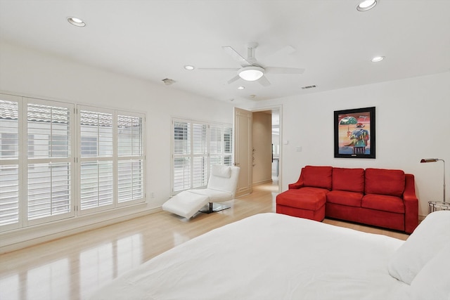 bedroom with light hardwood / wood-style floors and ceiling fan