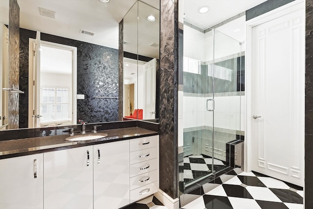 bathroom featuring vanity and an enclosed shower