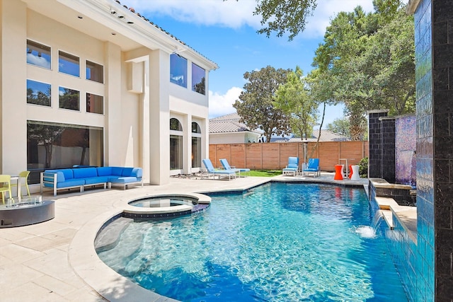 view of pool featuring a patio, outdoor lounge area, an in ground hot tub, and pool water feature