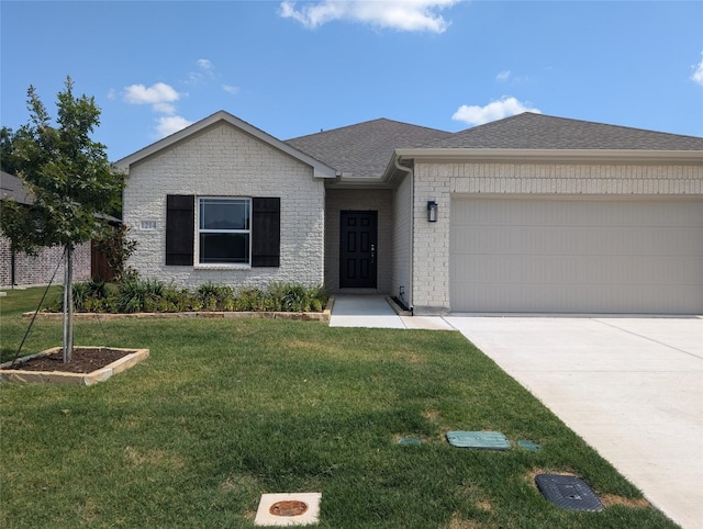 view of front of property featuring a front yard and a garage