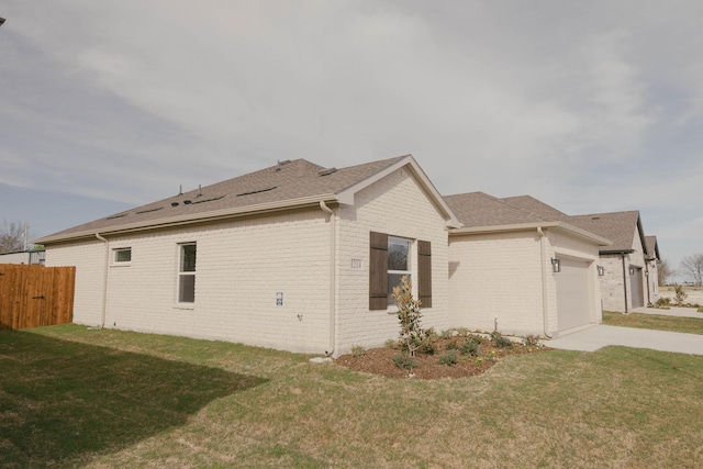 view of home's exterior featuring a yard and a garage