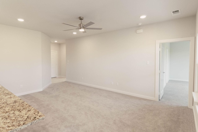 carpeted spare room with ceiling fan