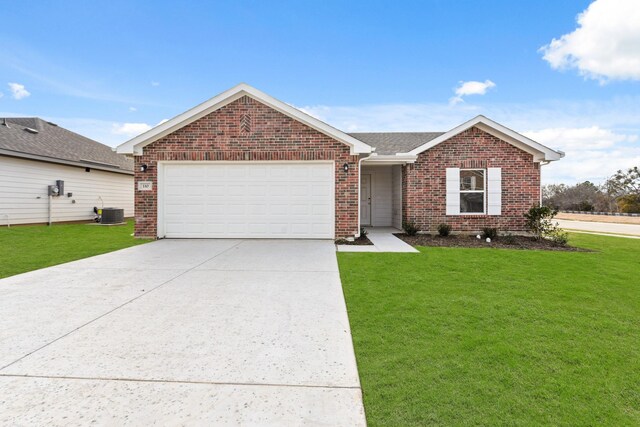 single story home featuring a garage and a yard