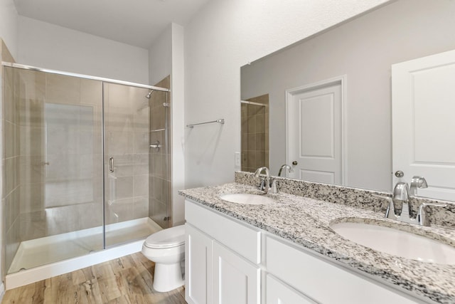 bathroom with vanity, wood-type flooring, toilet, and walk in shower