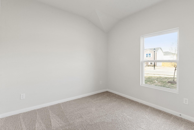 empty room with lofted ceiling and carpet floors