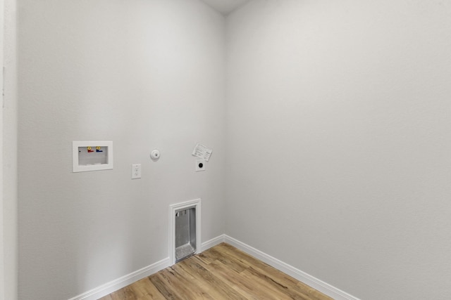 laundry area featuring electric dryer hookup, hookup for a gas dryer, hookup for a washing machine, and light wood-type flooring