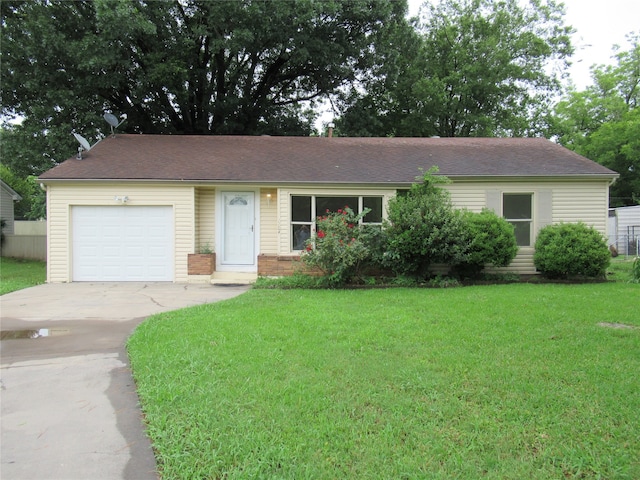 ranch-style home with a front lawn and a garage