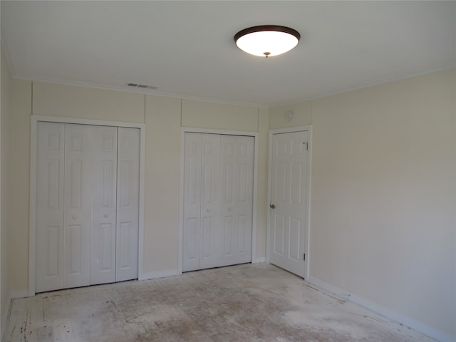 unfurnished bedroom featuring multiple closets