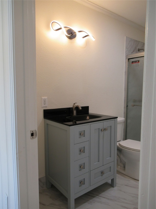 bathroom with vanity, toilet, a shower with door, and crown molding