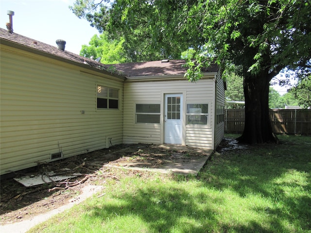 rear view of property featuring a yard