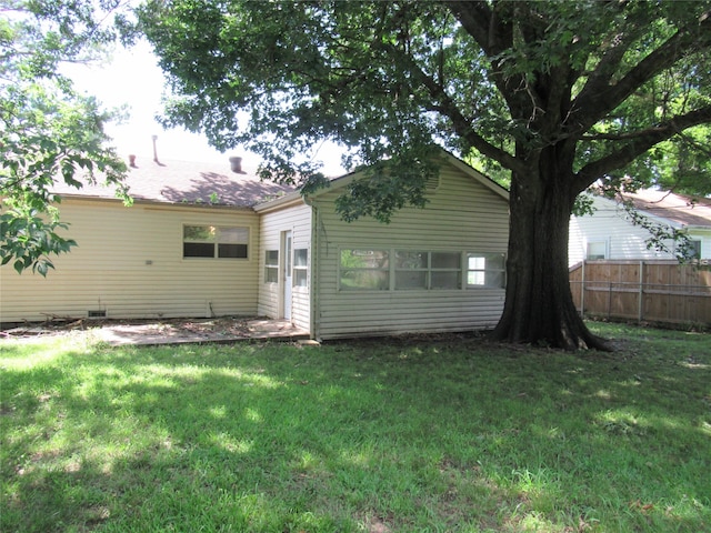 rear view of property with a yard