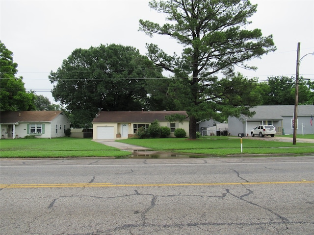 ranch-style house with a front yard and a garage