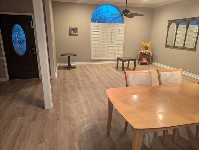 dining space featuring hardwood / wood-style flooring, ceiling fan, ornamental molding, and a textured ceiling