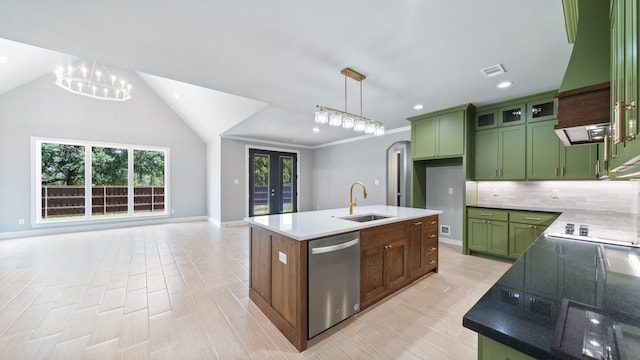 kitchen with tasteful backsplash, pendant lighting, sink, dishwasher, and a kitchen island with sink