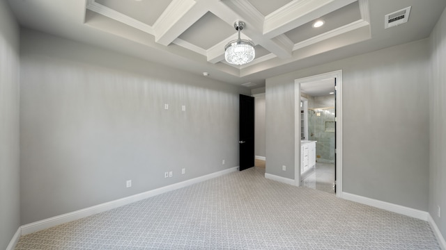 unfurnished bedroom with an inviting chandelier, beamed ceiling, coffered ceiling, carpet, and ensuite bath