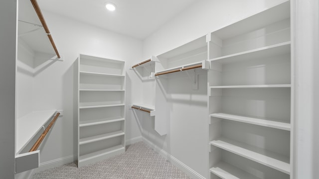 walk in closet featuring carpet flooring