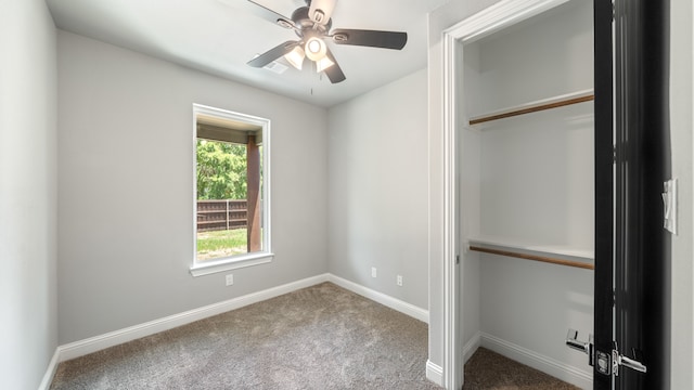 unfurnished bedroom with carpet floors, ceiling fan, and a closet