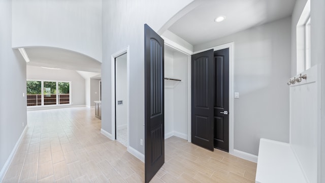 corridor with light hardwood / wood-style flooring