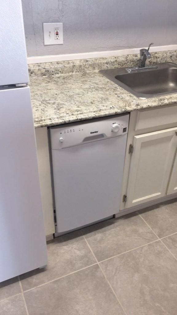 details with white cabinetry, sink, and white appliances