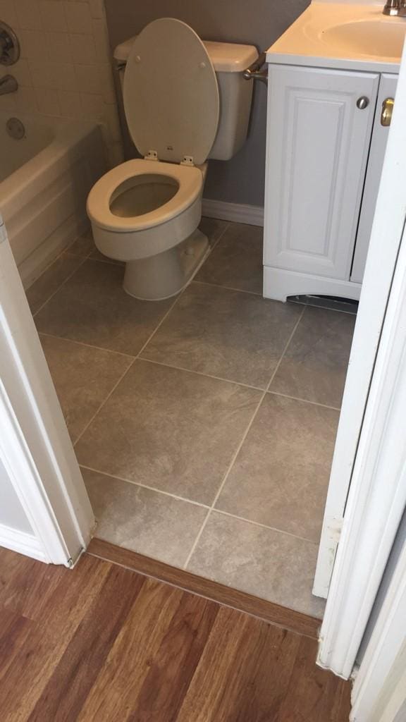 bathroom with tile patterned floors, vanity, and toilet