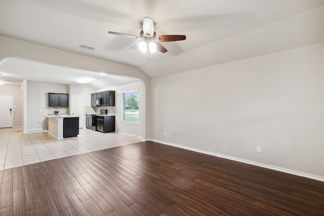 unfurnished living room with light tile patterned floors and ceiling fan