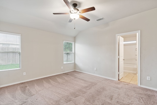 empty room featuring light carpet, ceiling fan, and lofted ceiling