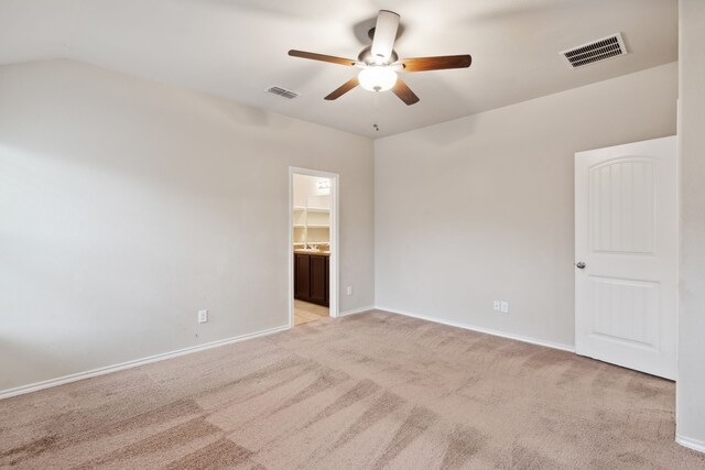 carpeted empty room with ceiling fan and vaulted ceiling