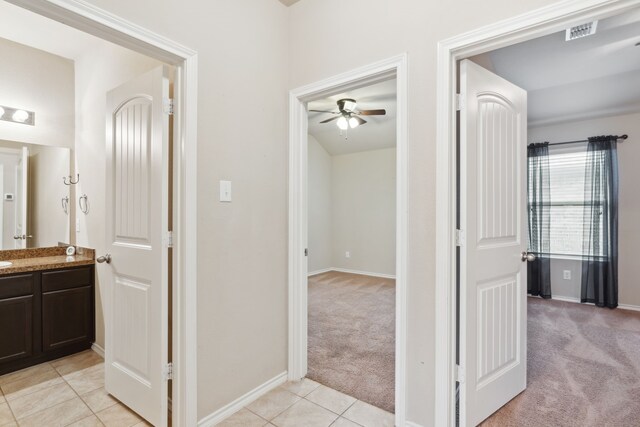 hallway featuring light carpet