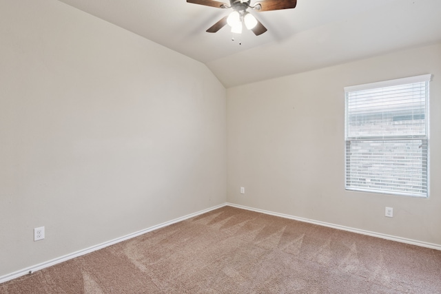 spare room with ceiling fan, lofted ceiling, and carpet