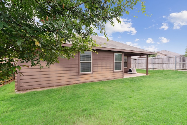 back of property featuring a patio and a lawn