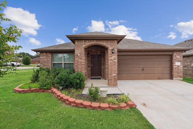 view of front of home featuring a garage and a front yard